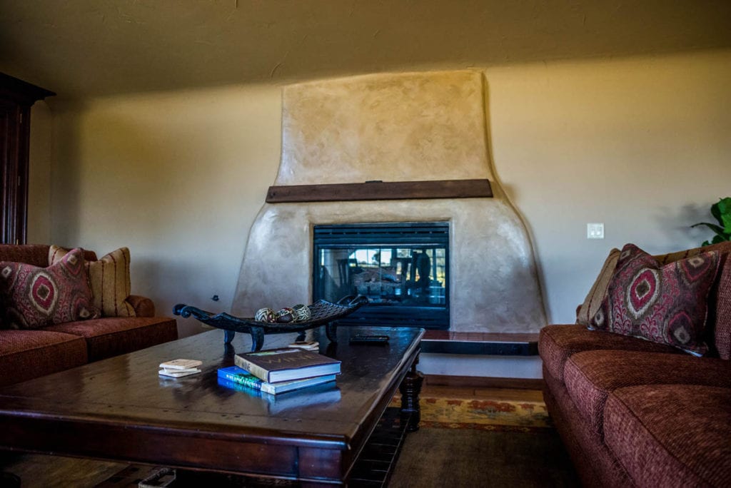living room with chimney at vineyard house in Amador County - Jeff Runquist Wines